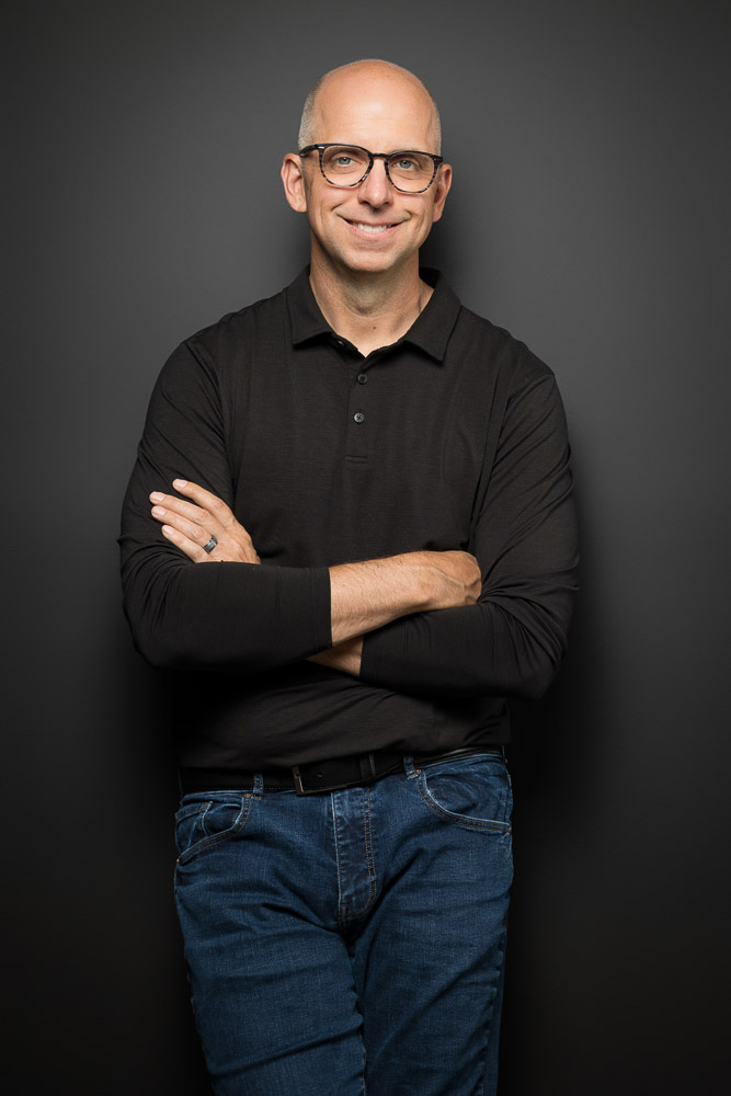 Pat Miller standing, arms crossed